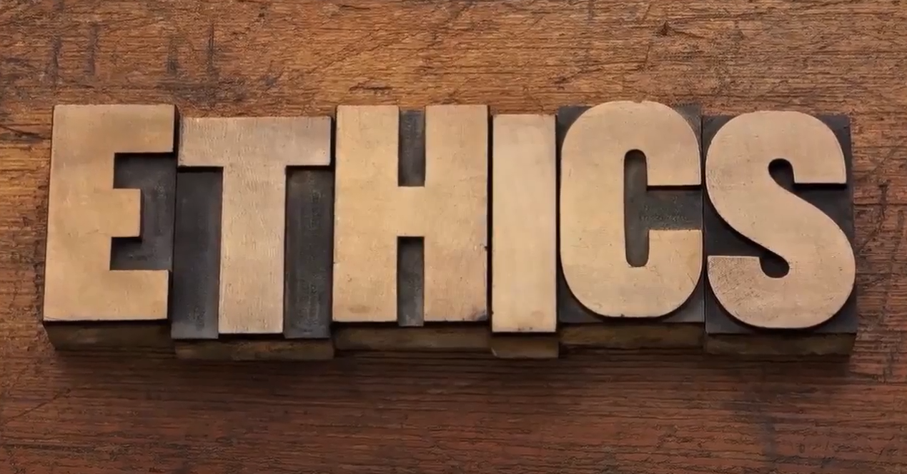 Ethics spelled out on wood background