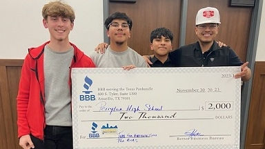 photo of previous winners holding large checks