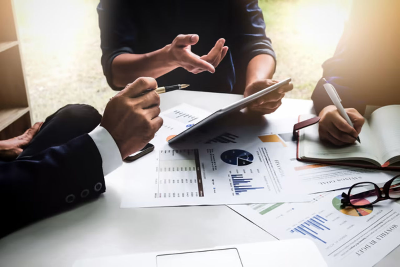 Group of business people reviewing reports