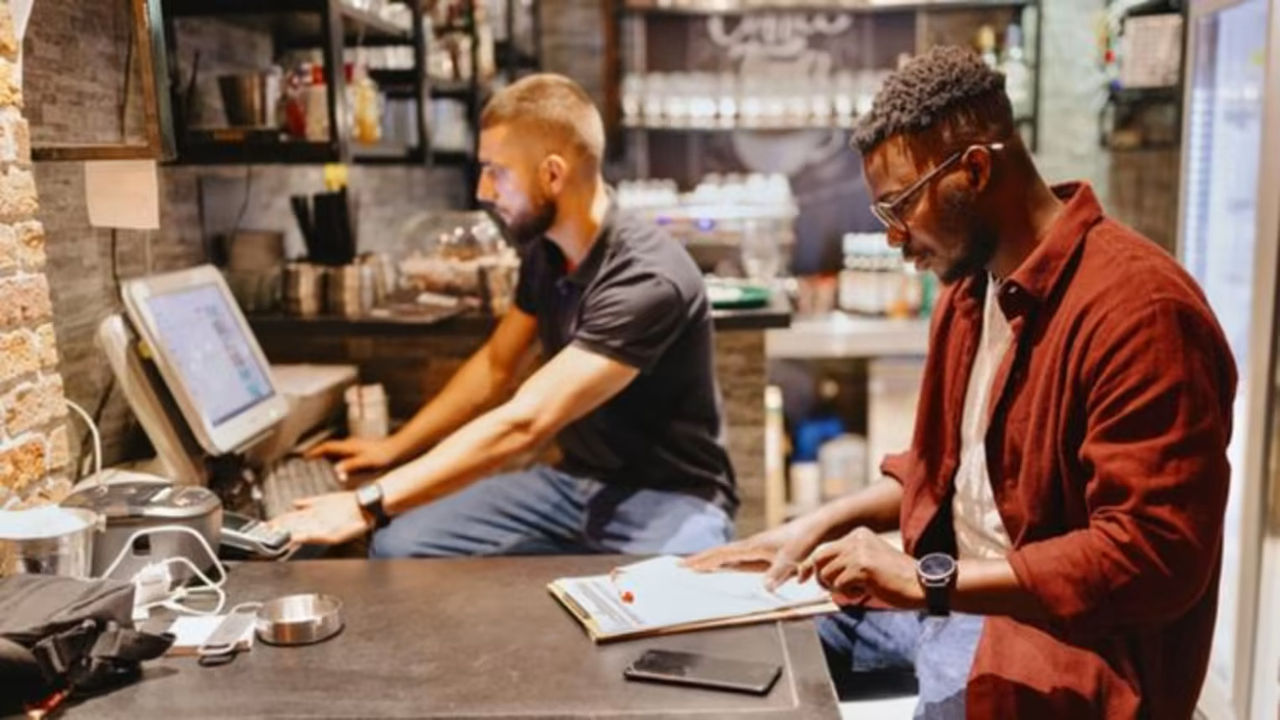 2 restaurant workers reviewing a budget