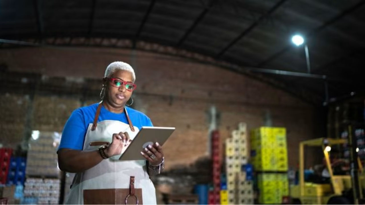 Business owner using a tablet in a warehouse