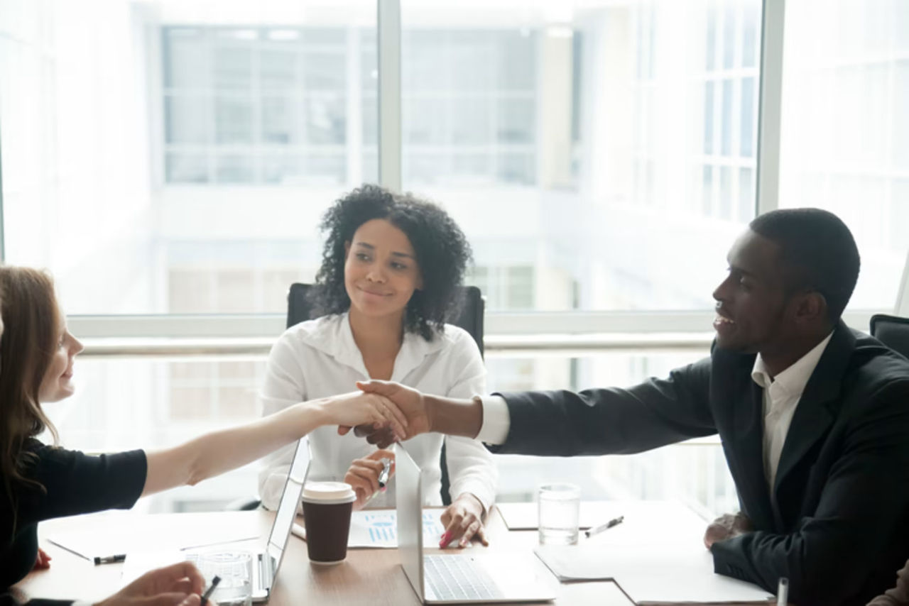2 employees shaking hands after a resolution