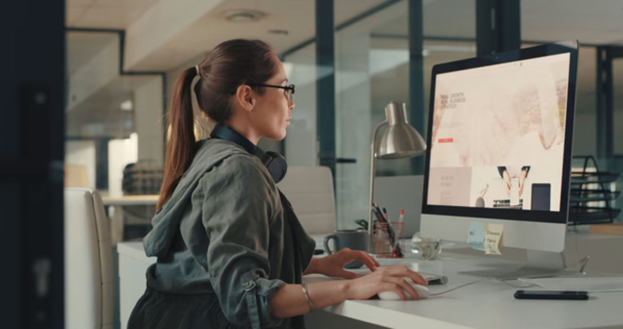 Woman at desk working on computer
