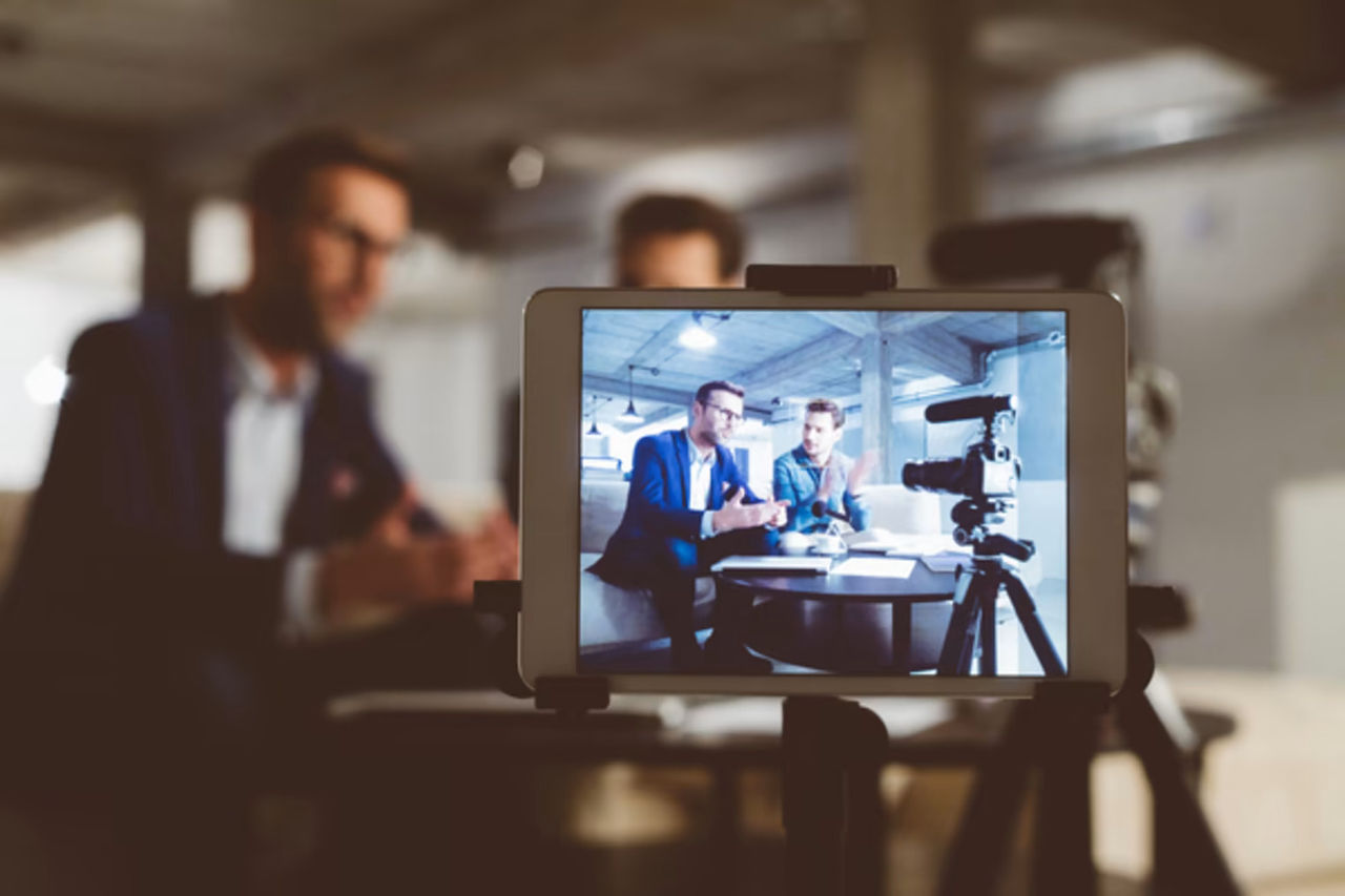 2 business men filming a video