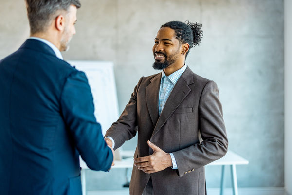 Cheerful Businessmen greeting each other for new partnership.