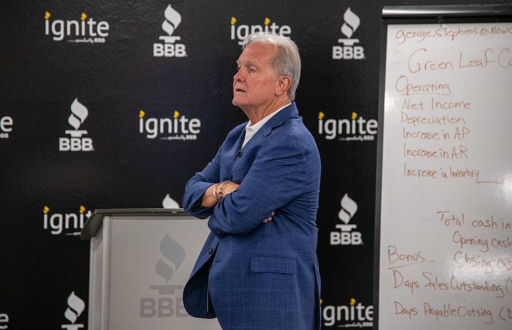 White male speaking with arms crossed at Ignite Center.