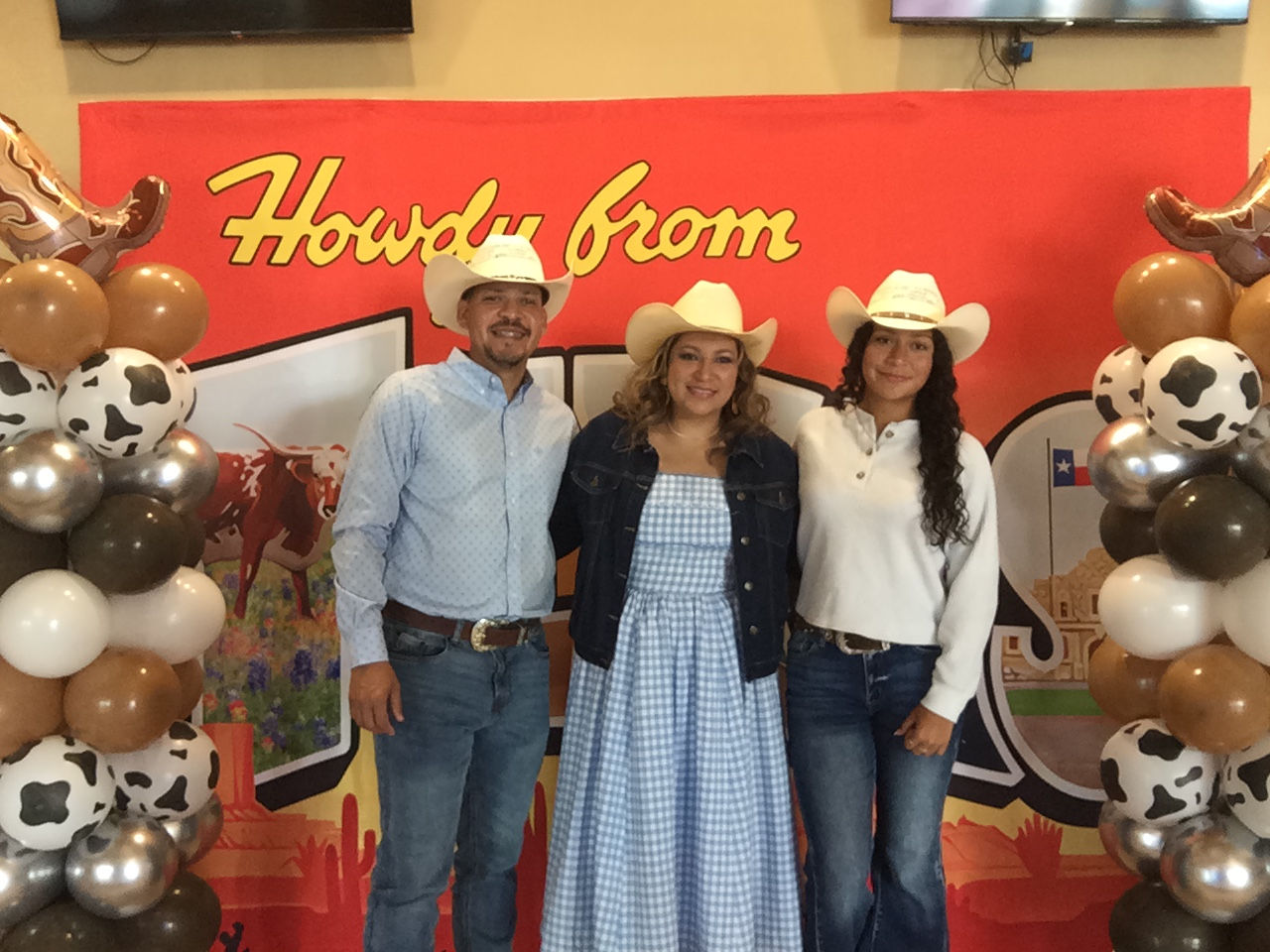 3 people in hats at a photo booth