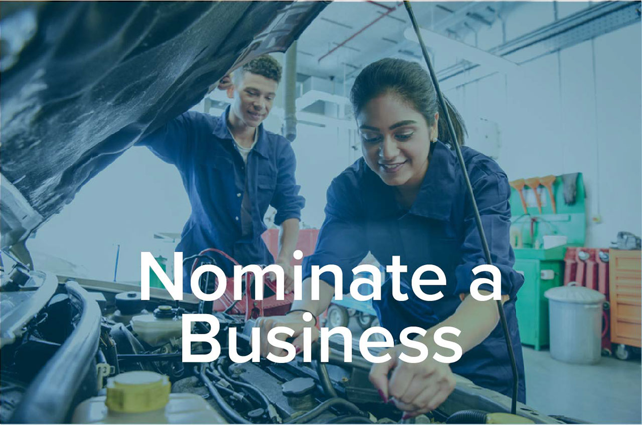 Nominate a Business text over an image of mechanics working on a car
