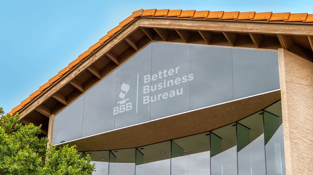 front entrance to the BBB Business and Community Center with words Better Business Bureau and BBB logo on the windows