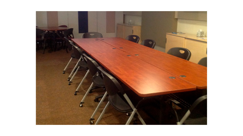 large room with long table and chairs 
