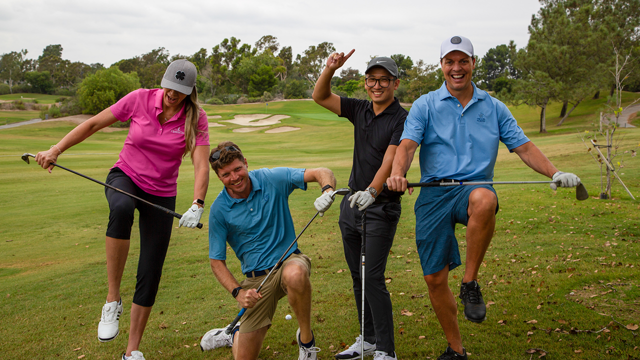 group of golfers making a silly pose for the camera