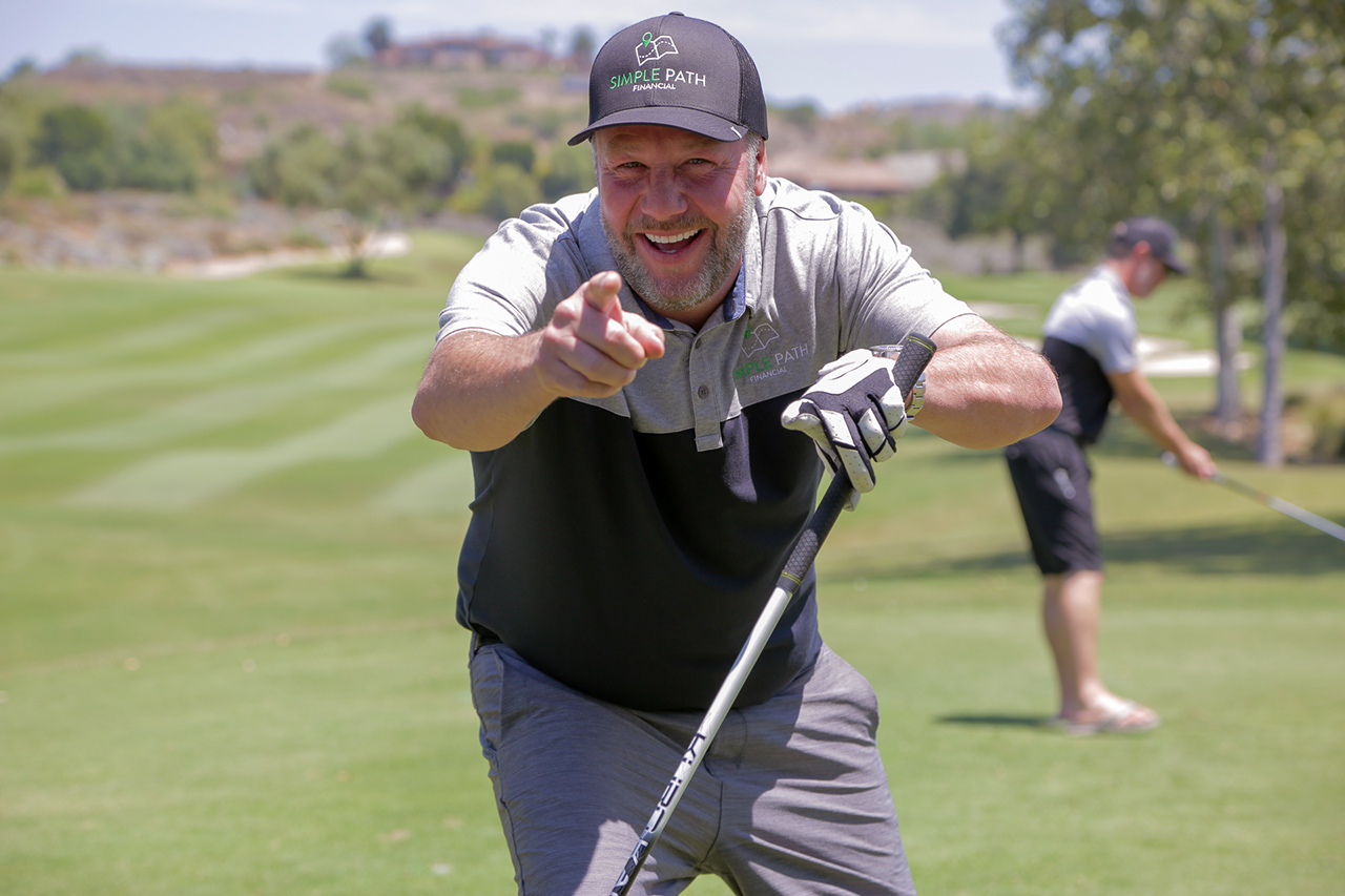 smiling golfer pointing at the camera
