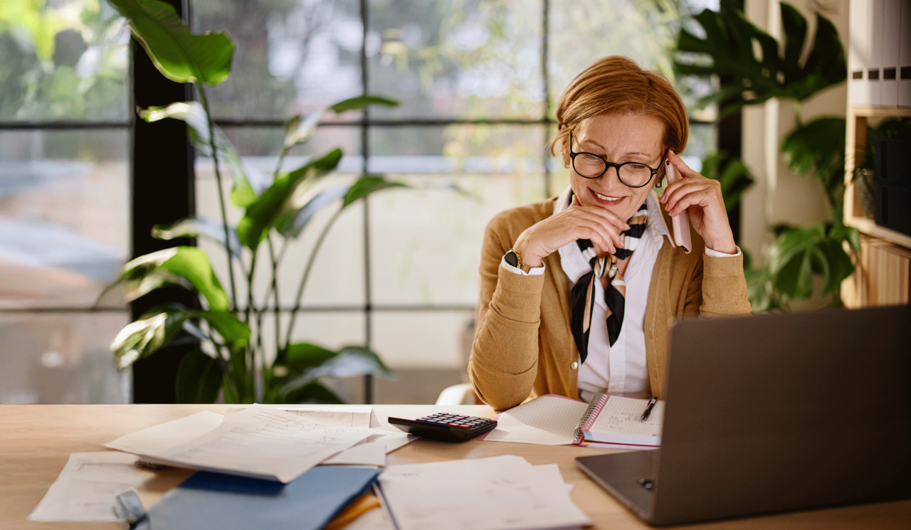 Middle aged businesswoman using laptop while working from home