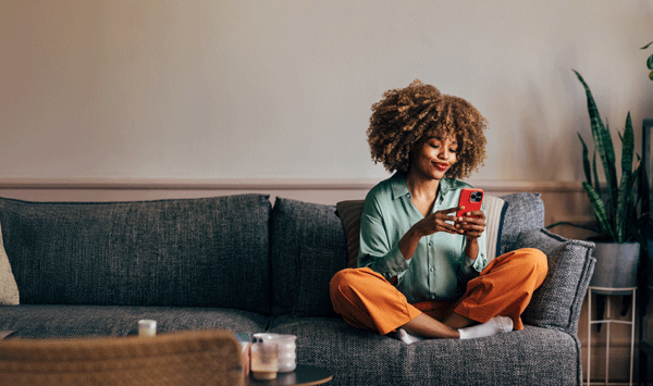 Woman sitting on ocuch on phone
