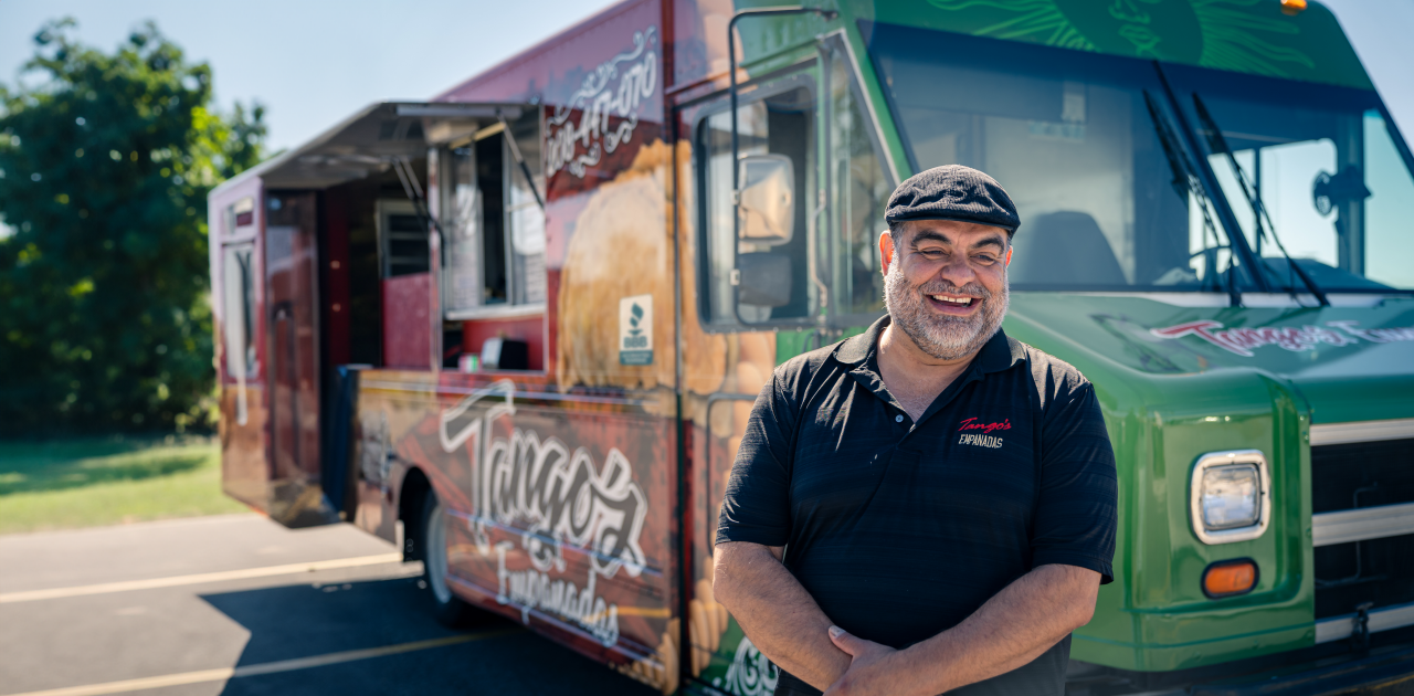 Man standing in front of food truck with BBB Seal on it