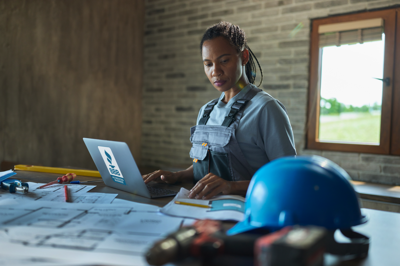 Construction worker on laptop with BBB Seal