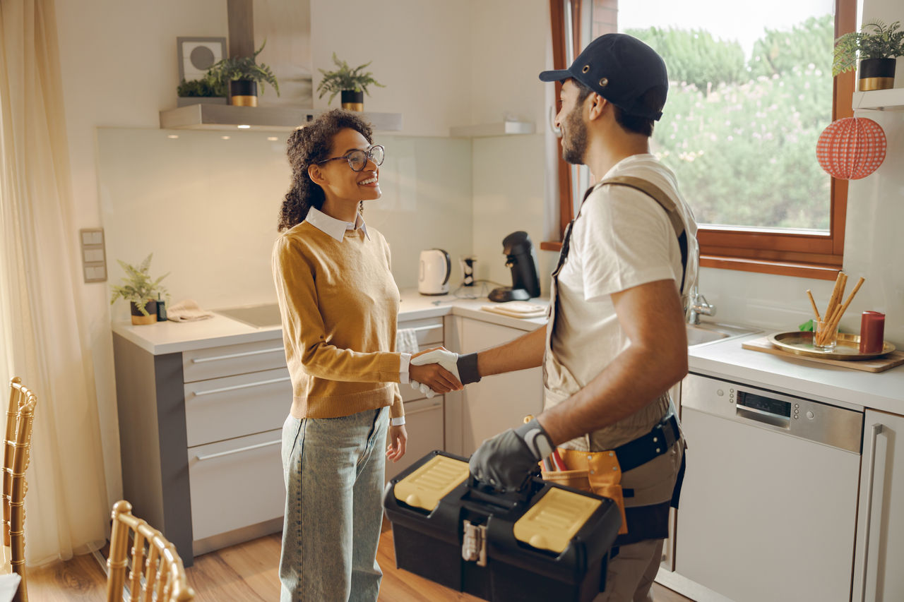 Happy customer shaking hands with service worker