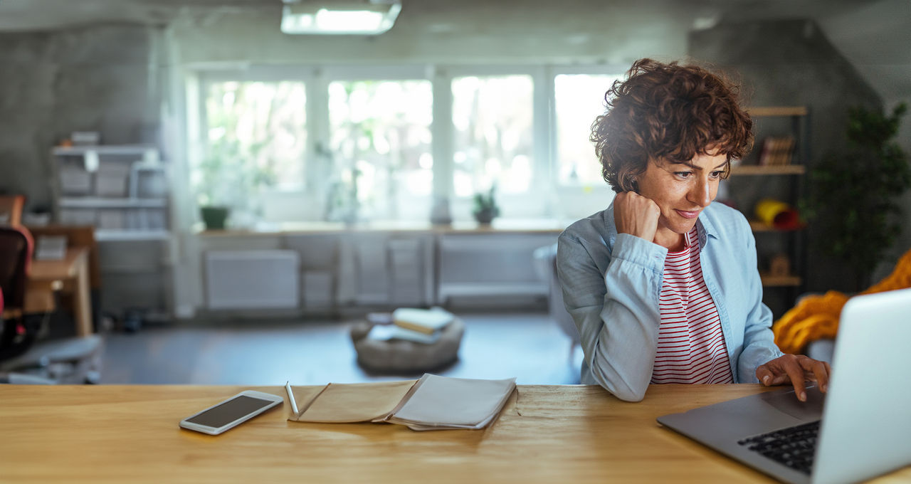 false Photo of mature woman working at home